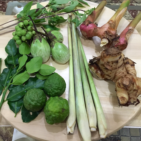 Clockwise from top right: pink galangal, yellow galangal (these are different types of galangal - either of which can be used), lemon grass stalk, kaffir lime, kaffir lime leaves, baby eggplants, brinjals, Thai basil